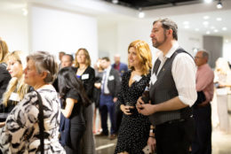 group of people at an event looking on to a performance