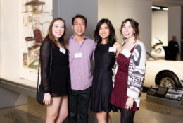 three women and one man smiling for photo