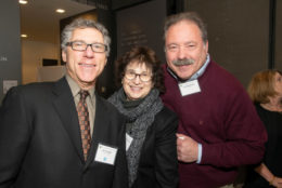 two men and a woman posing for photo