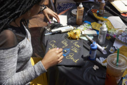 woman decorating cap preparing for graduation