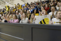 stadium full of cheering students at basketball game