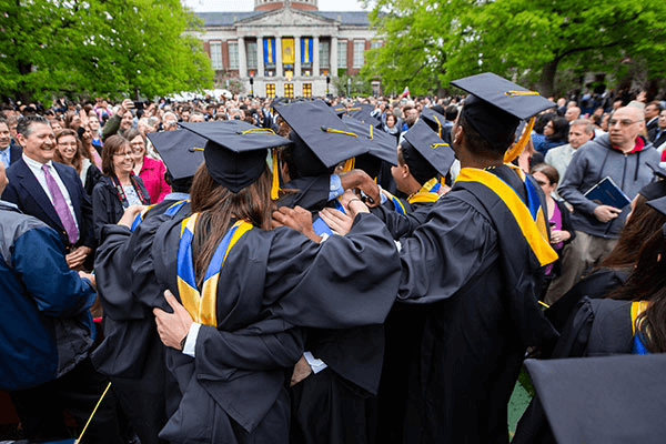 Back of students in cap and gown for graduation ceremony