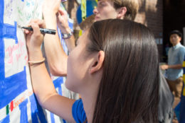 students adding comments on board