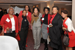 seven women standing and smiling for photo