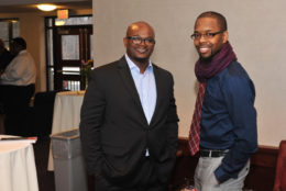 two men smiling at the camera