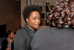 woman facing a group in a conversation