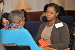 two women sitting facing each other talking