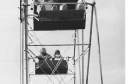 black and white photo of couple on ferris wheel