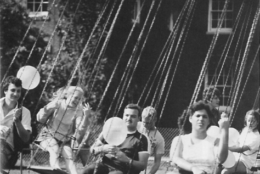 black and white photo of people on swing carnival ride