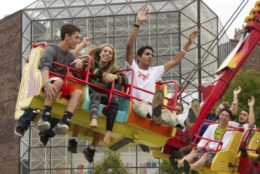 students on carnival ride with wilson commons in background