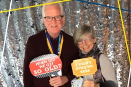 man and woman posing in photo booth