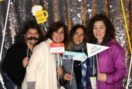 four women posing i photo booth