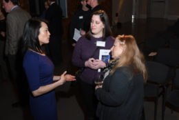 three women in a circle in conversation during event