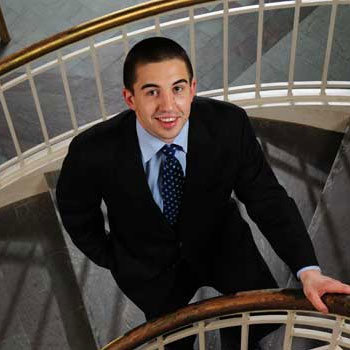 Student in a suit on staircase