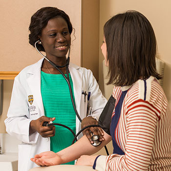 Healthcare worker taking patient's blood pressure