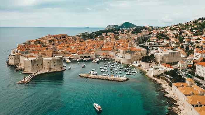 Aerial review of a coastal city in Croatia with blue water