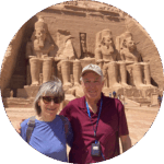 a couple posing for a picture in front of ancient egyptian ruins
