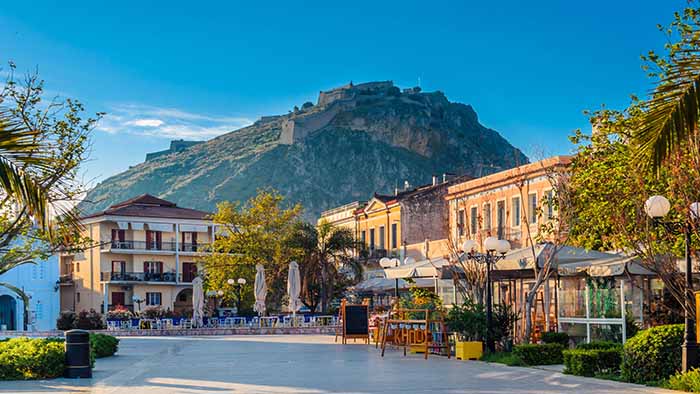 A town in Greece, with a mountain in the background