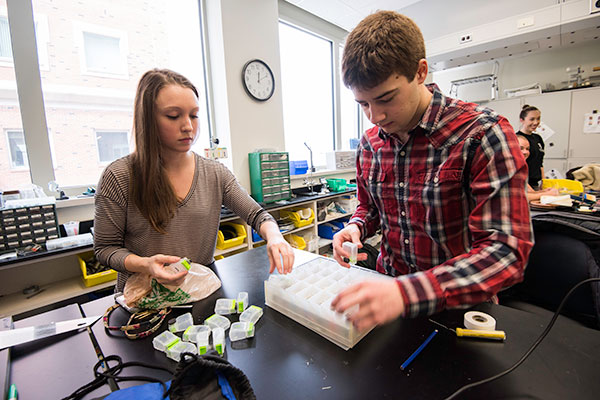 Two students working together in a classroom.
