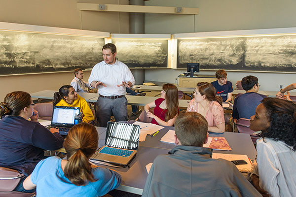 Students interacting with an instructor in a class.