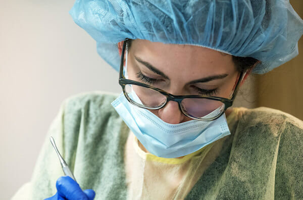 Dentist working on a person's teeth.