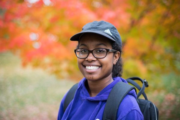 A student wearing a backpack outdoors