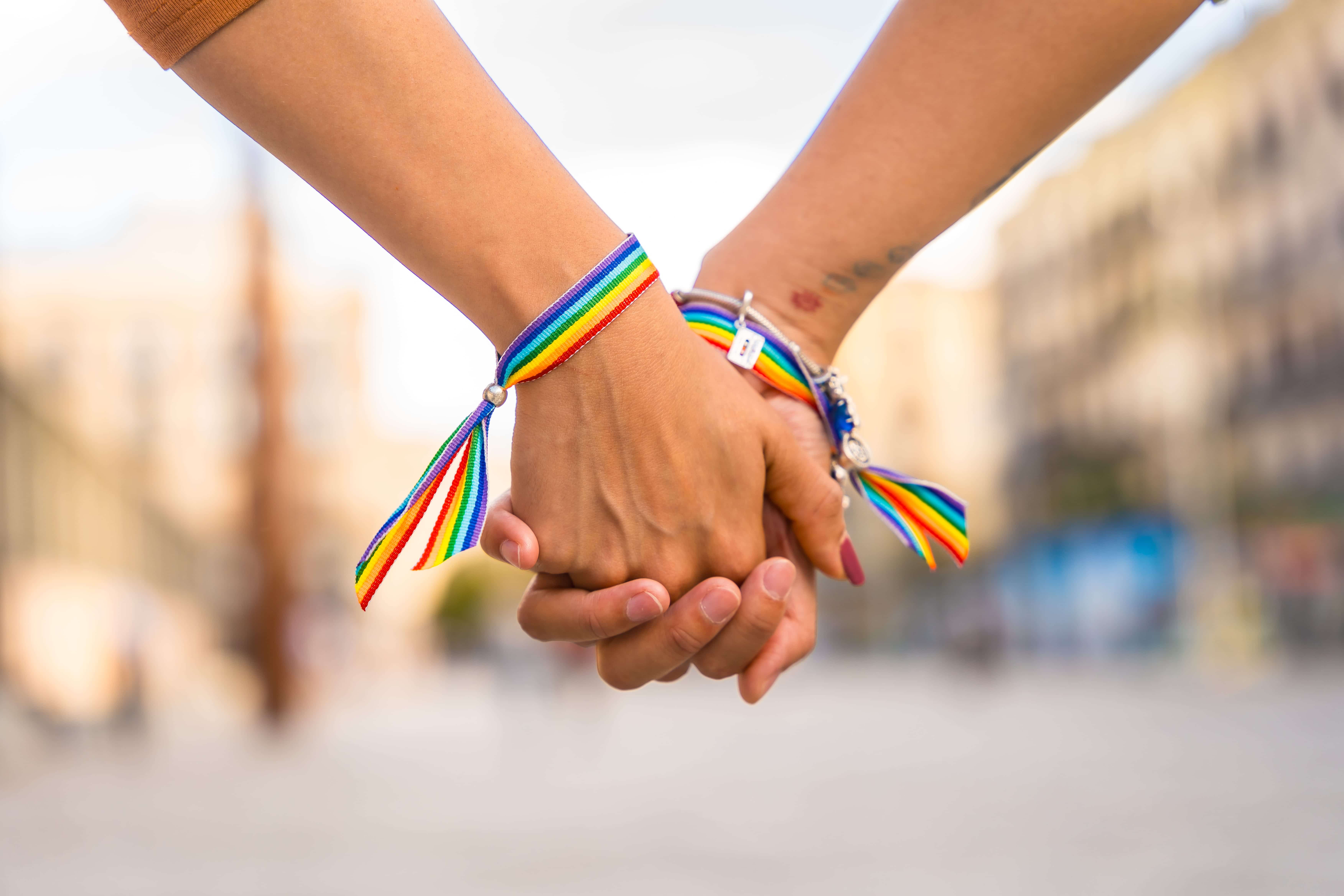A closeup of two people holding hands