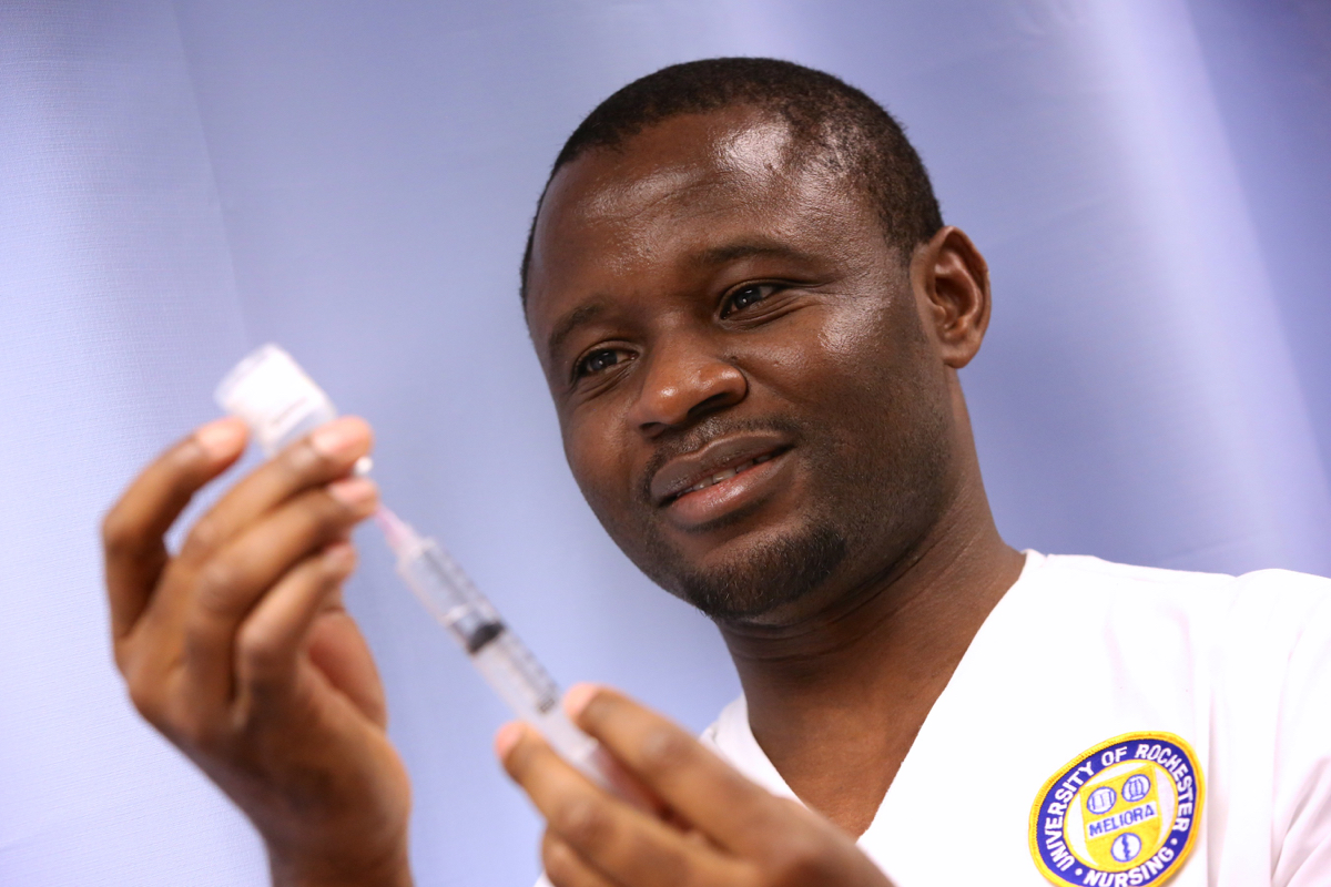 University of Rochester employee uses a syringe