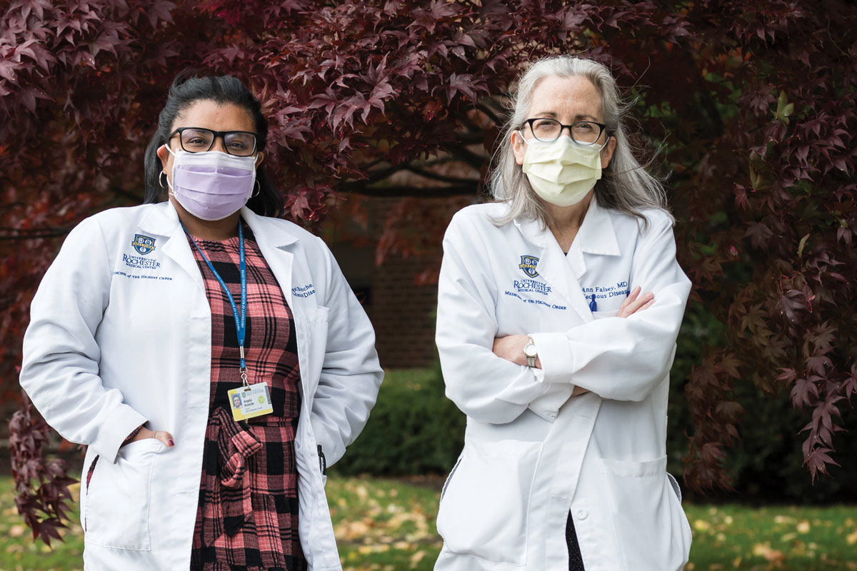 Two University of Rochester medical professionals wearing face mask and standing on the University campus. 