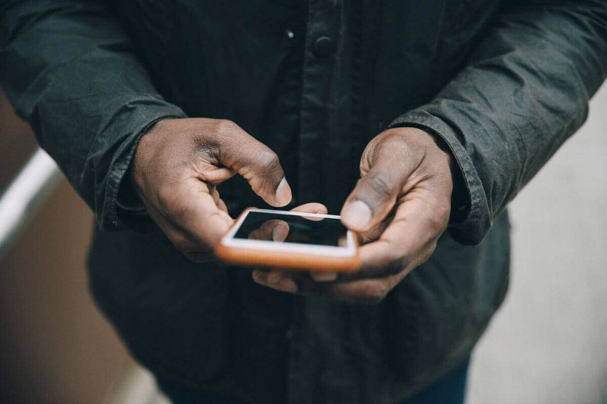 A person looking at their cell-phone.