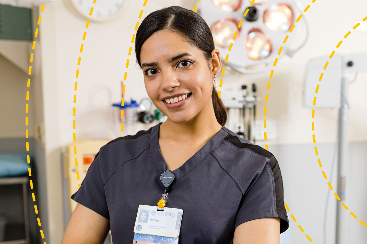 University of Rochester staff member poses for a photo in a hospital building.