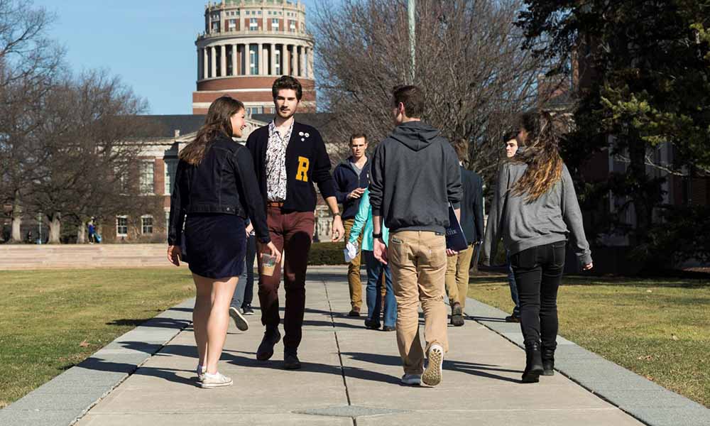 Two students giving perspective students a tour of the University of Rochester campus.