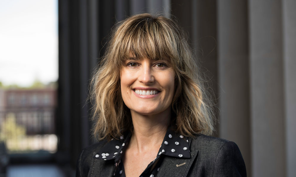 Gretchen Helmke, a woman with short hair in a polka dot shirt, named Guggenheim Fellow for her work in political science