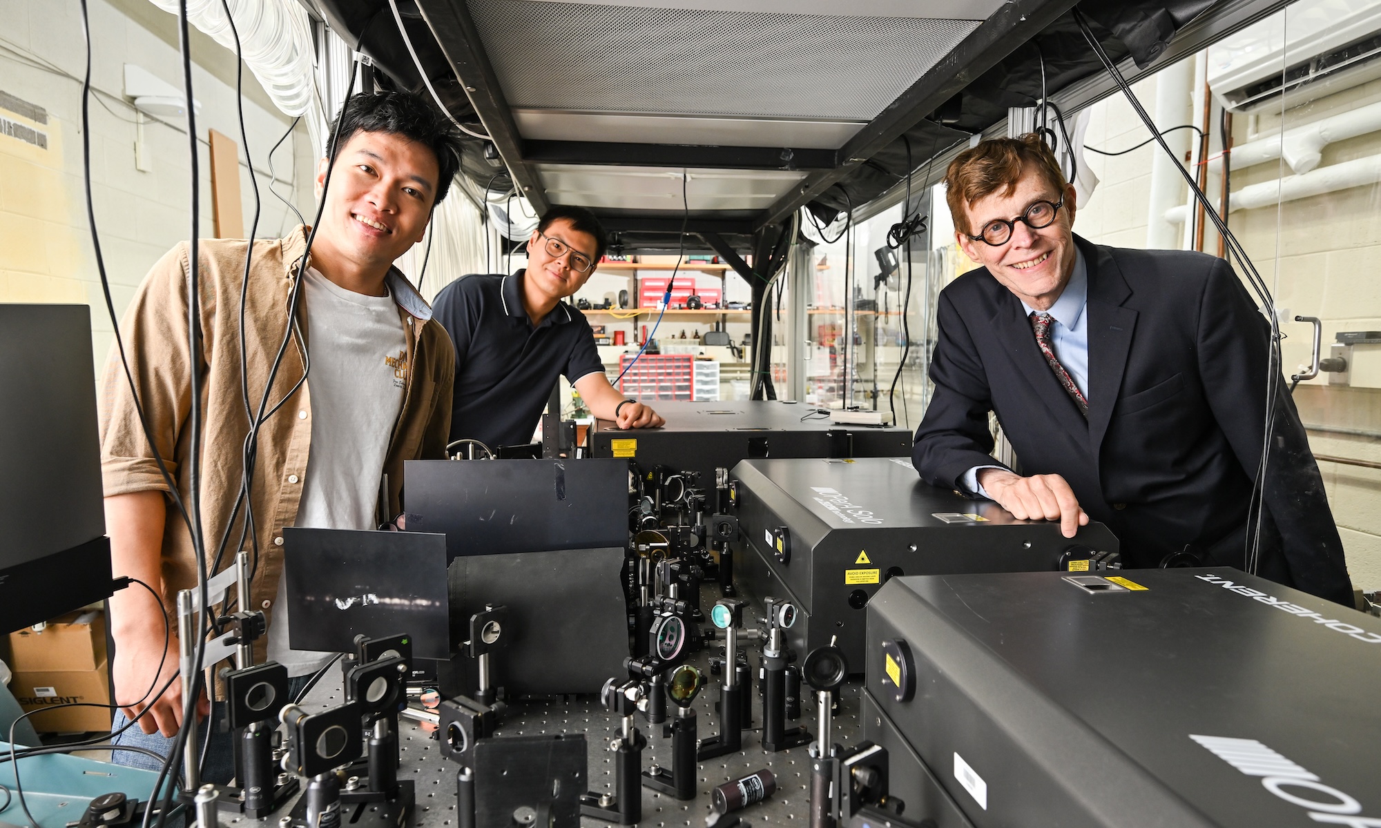 Long Nguyen, Yang Xu, and Robert Boyd in Boyd's lab. 