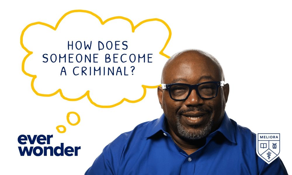 John Blackshear in front of a white background with a though bubble that says 'How does someone become a criminal?'