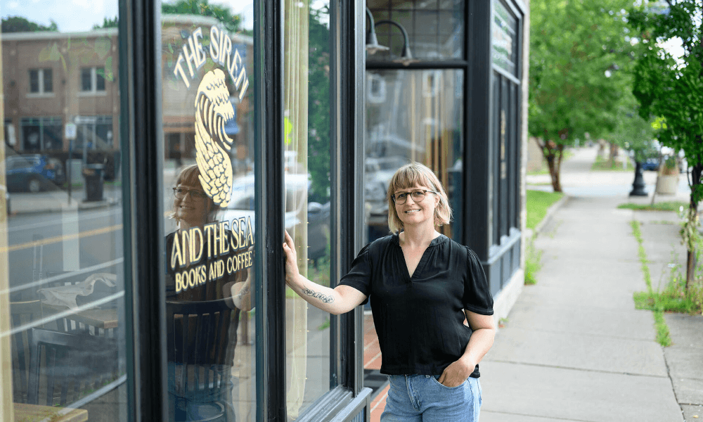 Jess Gale stands outside her store, The Siren and the Sea: Books and Coffee.