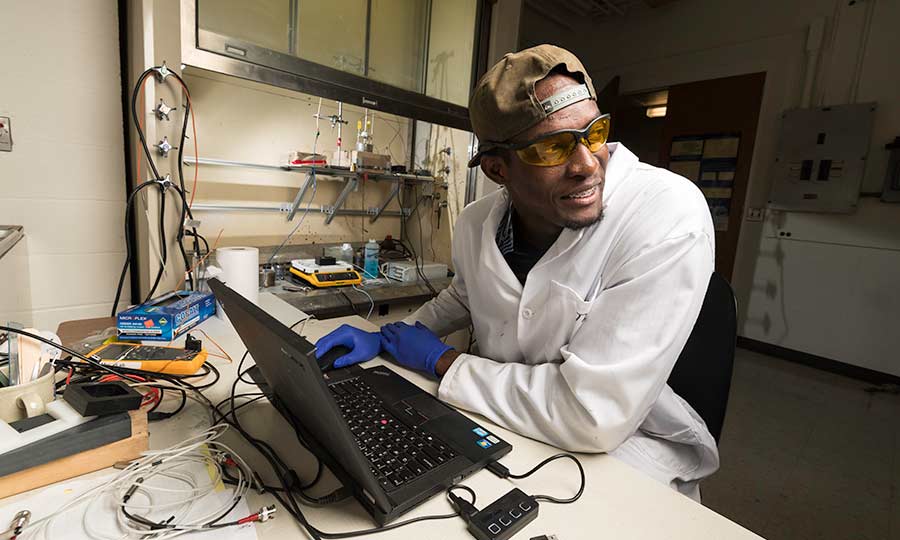 Researcher a laptop in lab at University of Rochester