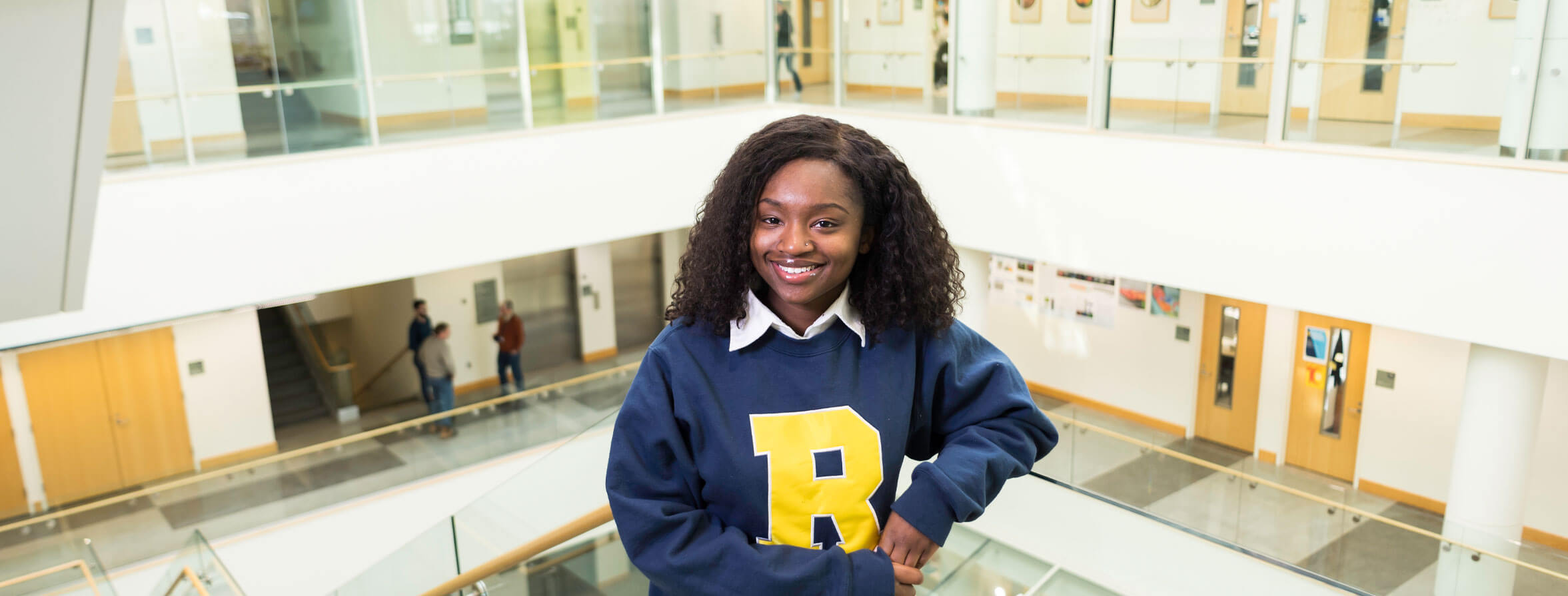 A University of Rochester Student studying at a cafe.