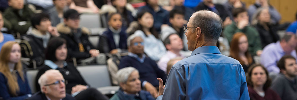 a professor lectures in a class auditoriam