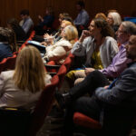 Attendees in the theatre audience watching the networking pitch session during the showcase.