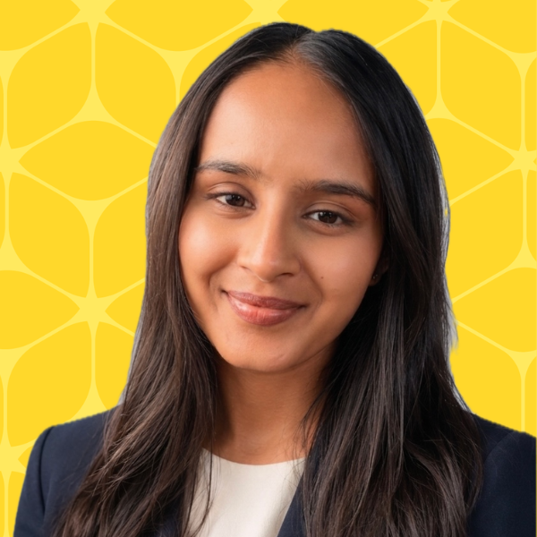 Hasini Sirigari headshot smiling with a yellow box background