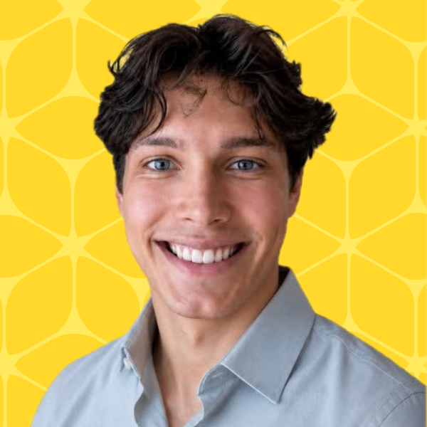 Yaroslave Matusevich headshot smiling with a yellow box background