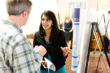 Epidemiology student presents her poster on “Attitudes, Beliefs, and Acceptance of Anal Cancer Screening of Men Who Have Sex with Men,” at the Undergraduate Research Exposition.