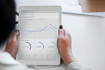 Woman holding a tablet with a financial report