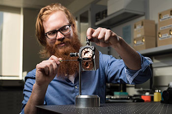 An optical engineering student working on a project