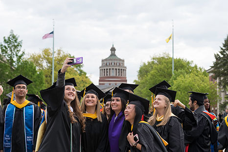 Students taking a selfie at commencement
