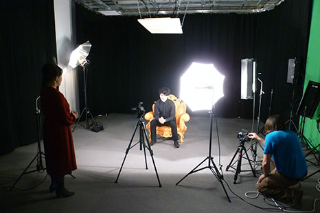Students using equipment during a photo shoot.