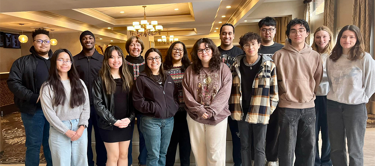 A diverse group of people smiling at the camera.