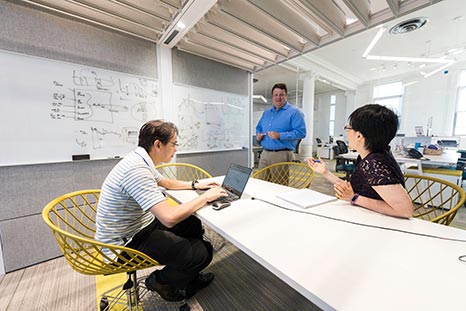 Three people working together on a problem.