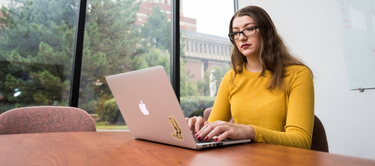 A woman studying at a table.